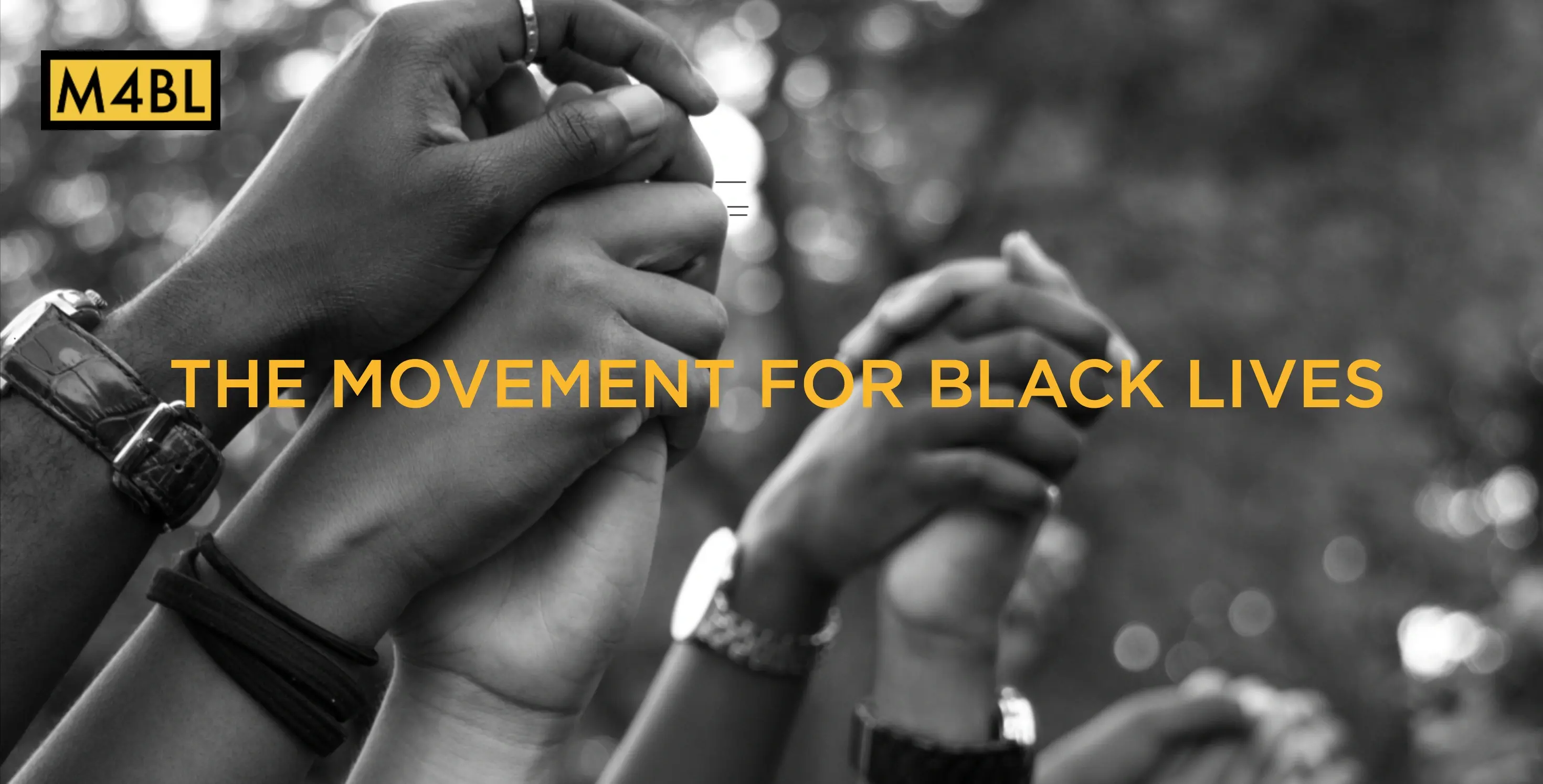 screenshot from M4BL website showing black and white photo of hands held together up in the air, yellow text reads 