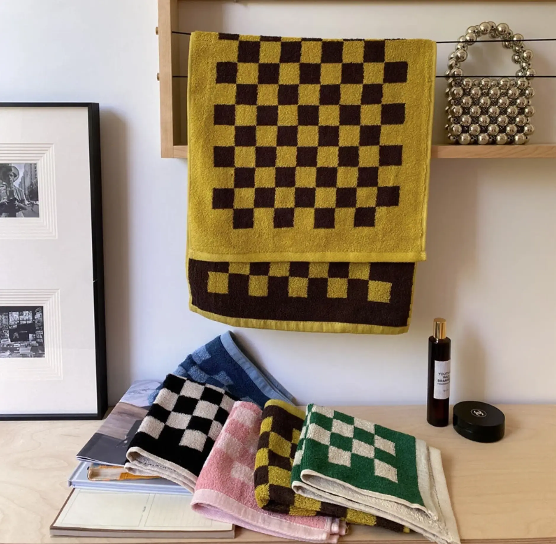 checkered towels lined up on a butcher block counter