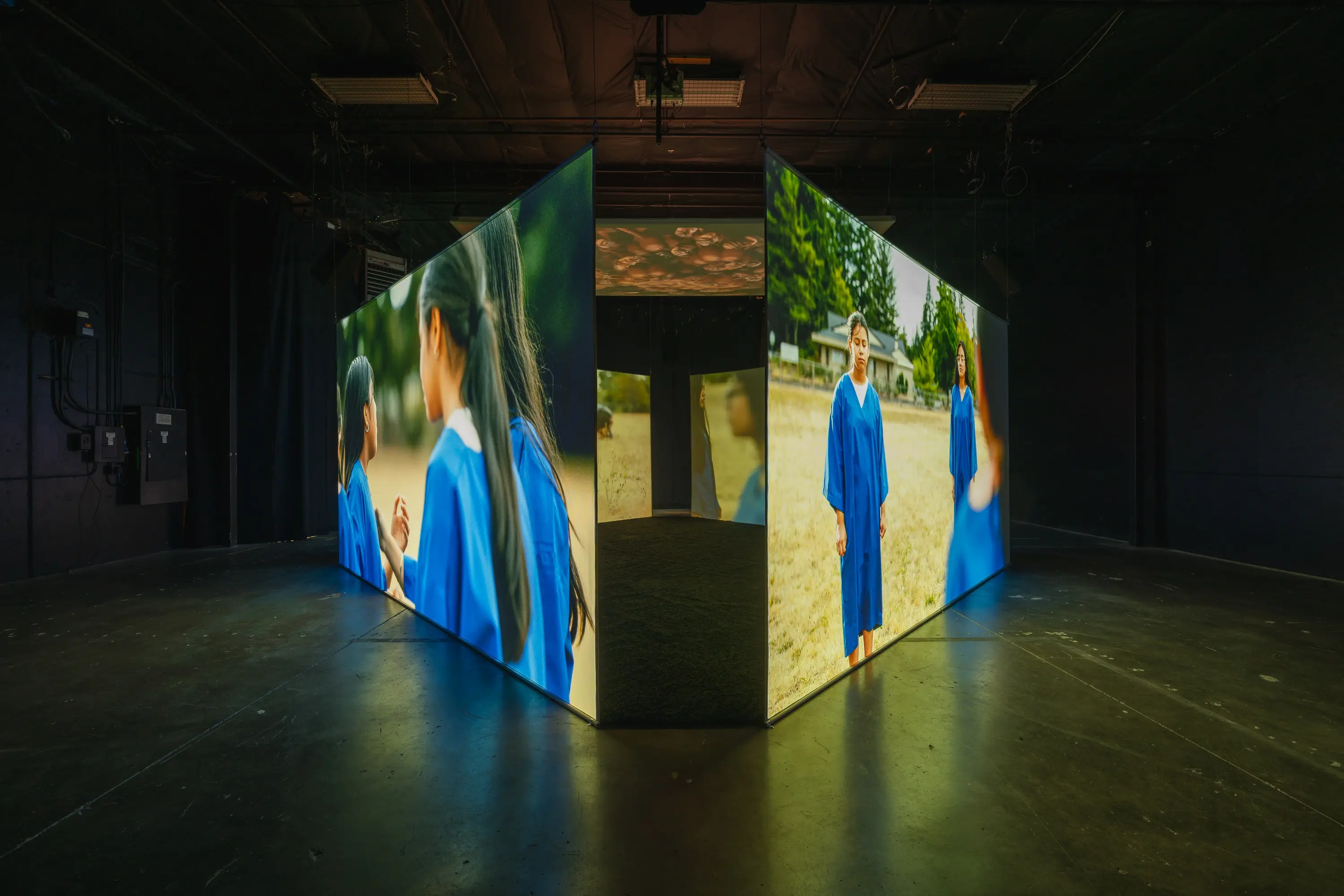 multi-screen installation with large projectors in a dark room