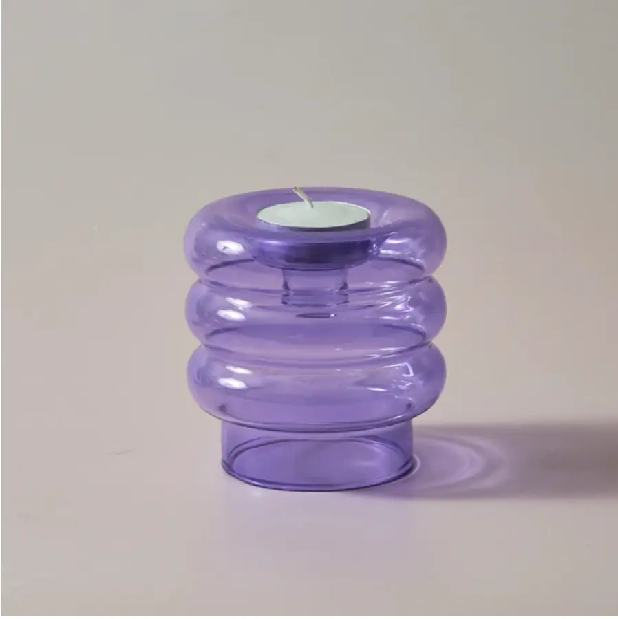 small, light purple glass candle holder in white space