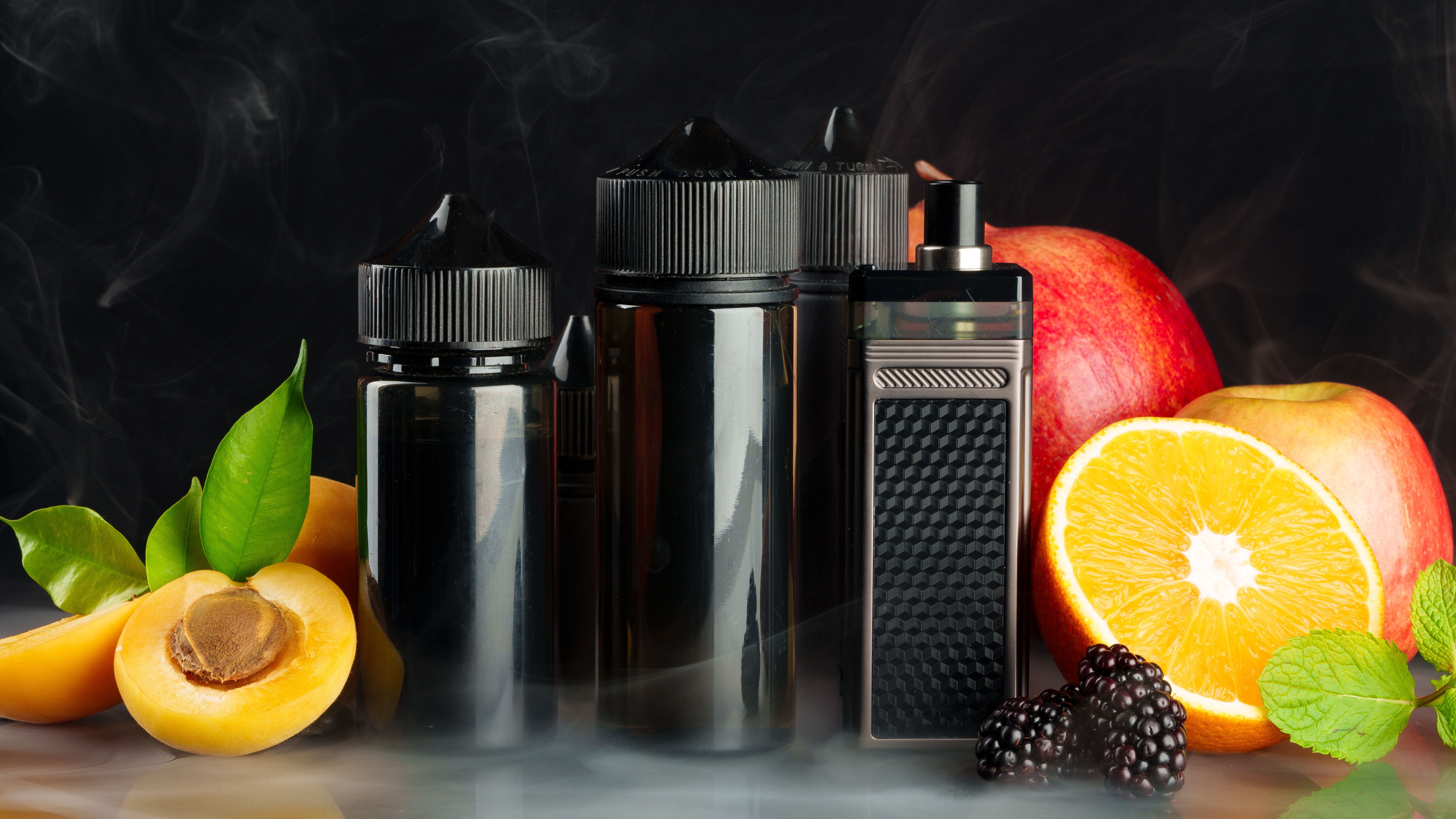 vape-and-smoking-liquid-with-fruit-against-black-b-2025-03-01-04-41-18-utc.jpg