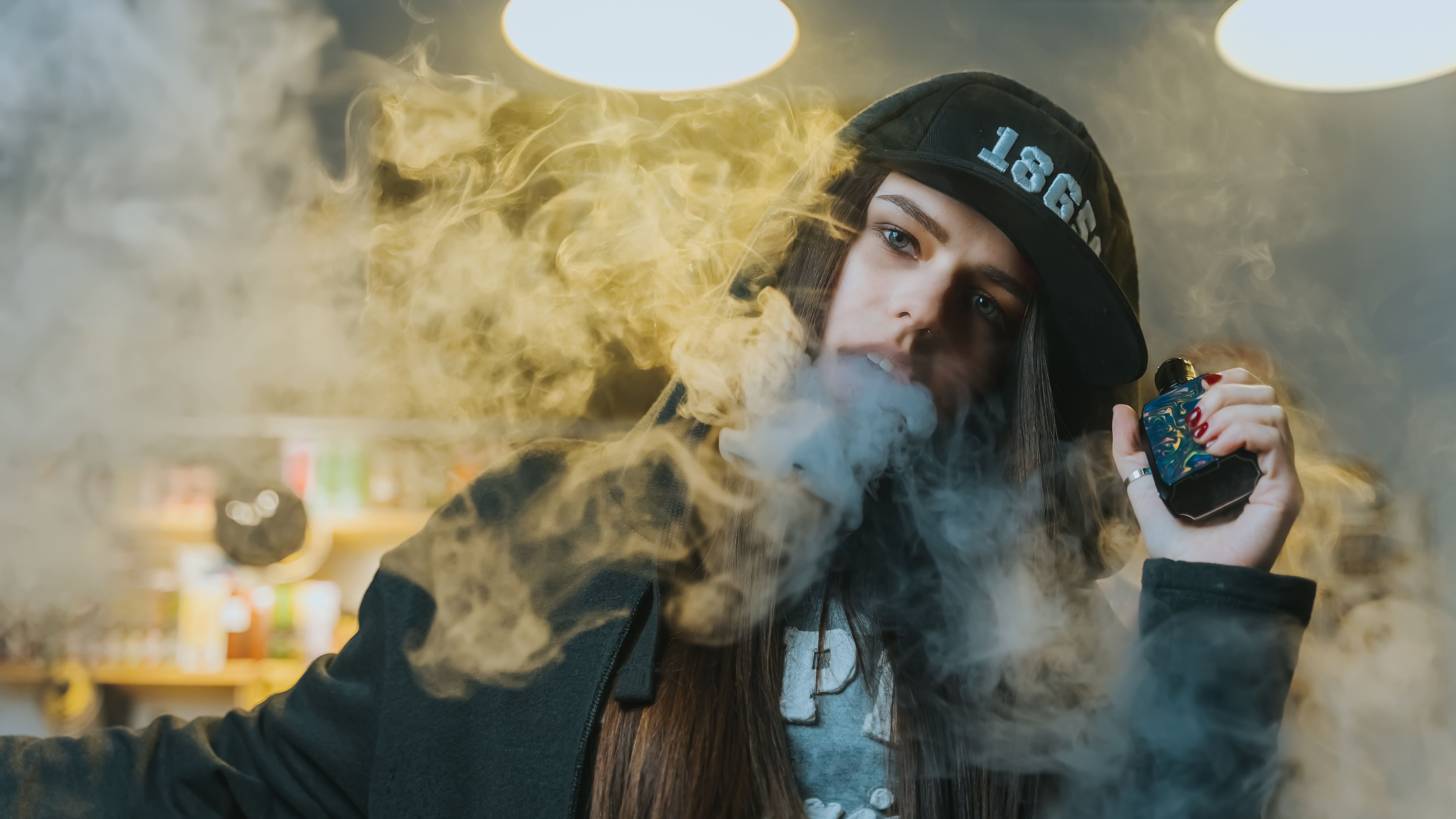 young-pretty-woman-in-cap-smoke-an-electronic-ciga-2025-01-29-04-39-49-utc.jpg