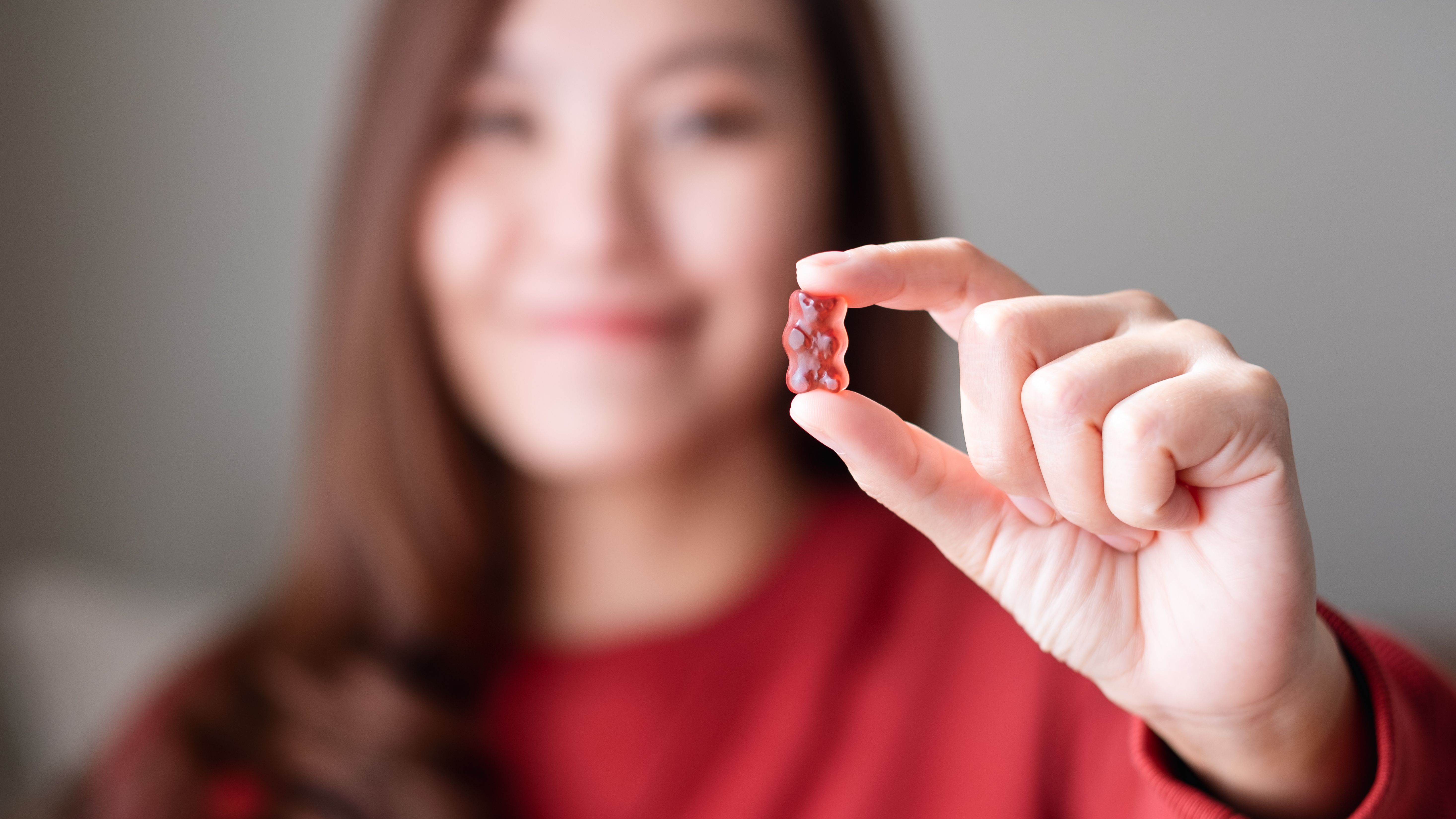 blurred-image-of-a-young-woman-holding-and-showin-2024-11-30-13-11-29-utc.jpg