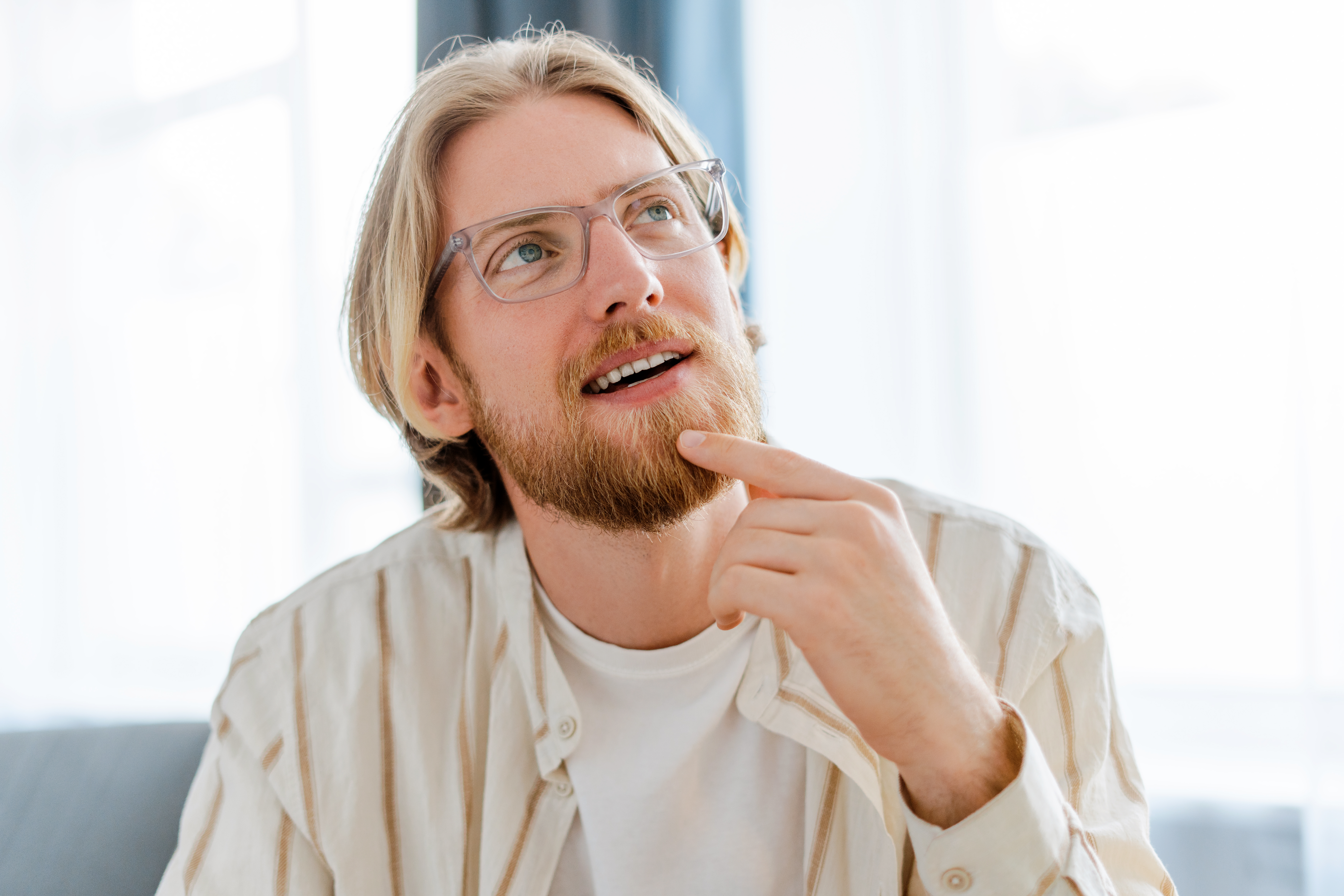 pensive-male-freelancer-thinking-and-looking-up-in-2025-02-20-11-11-22-utc.jpg