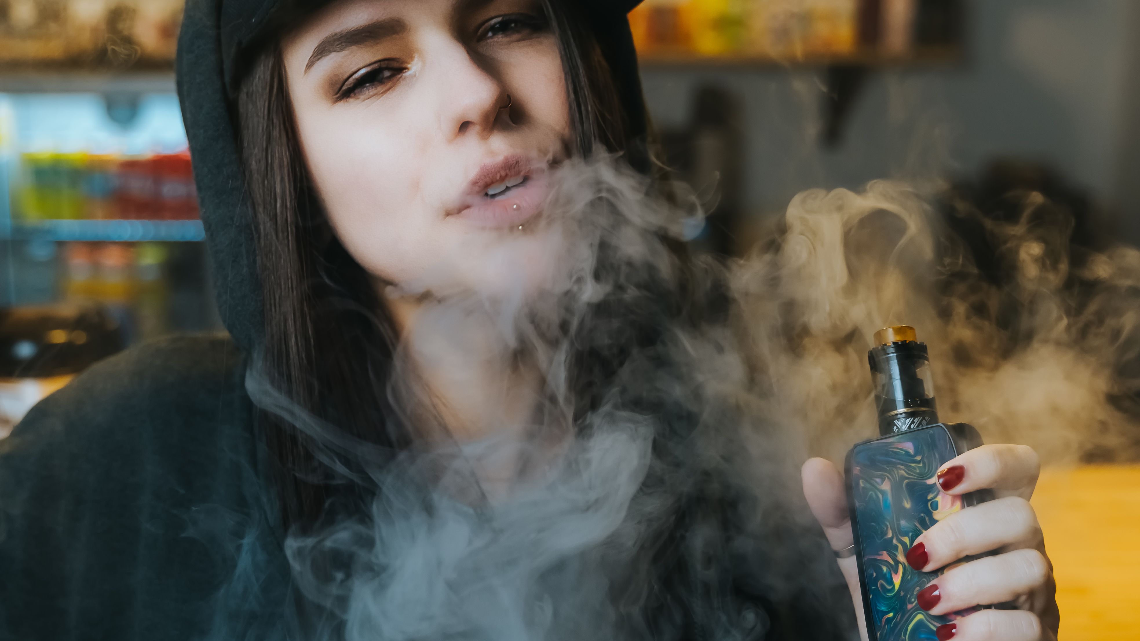 young-pretty-woman-in-cap-smoke-an-electronic-ciga-2025-01-29-04-38-05-utc.jpg