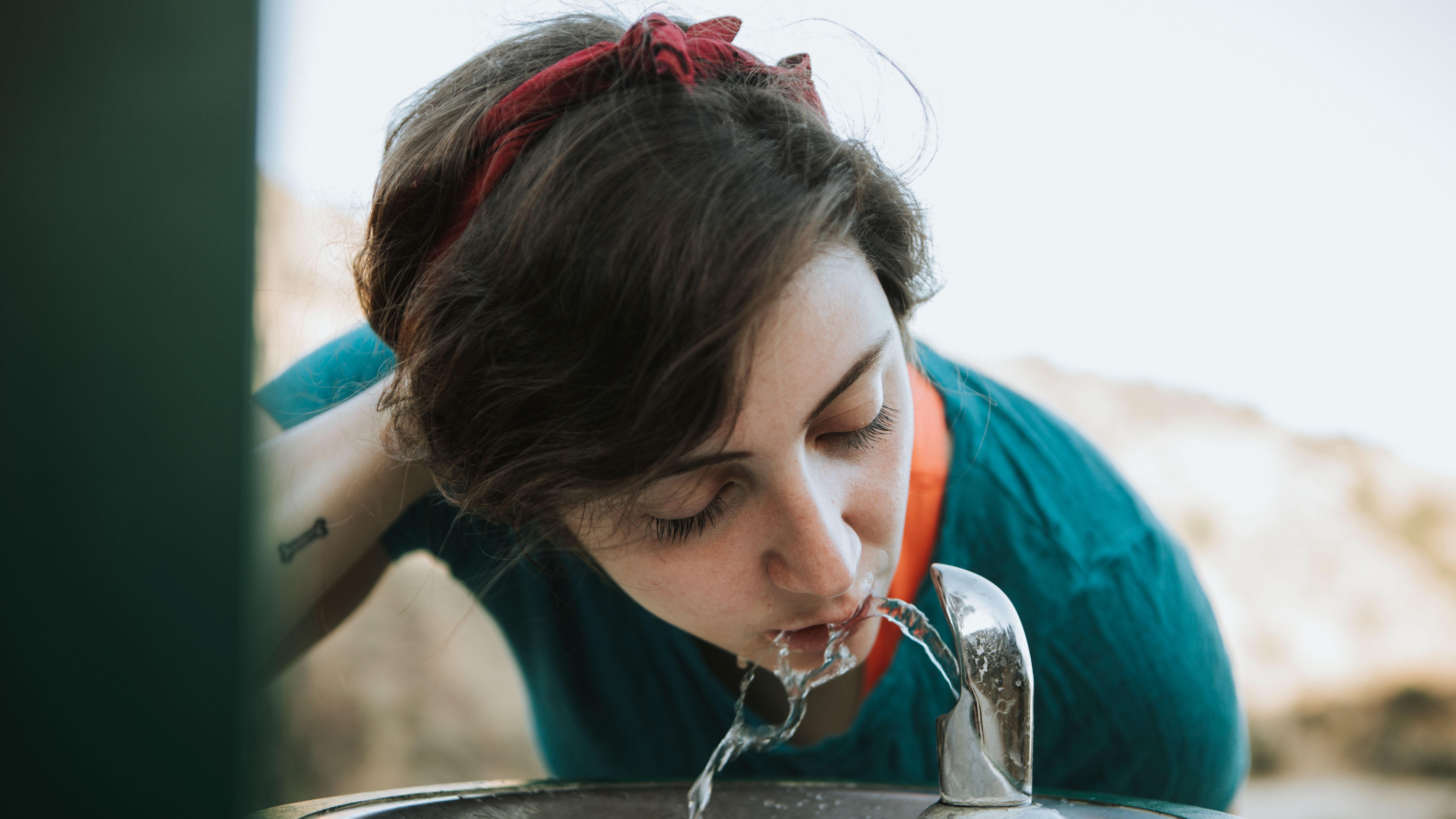 woman-drinking-water-from-a-water-fountain-2025-02-10-00-17-24-utc.jpg