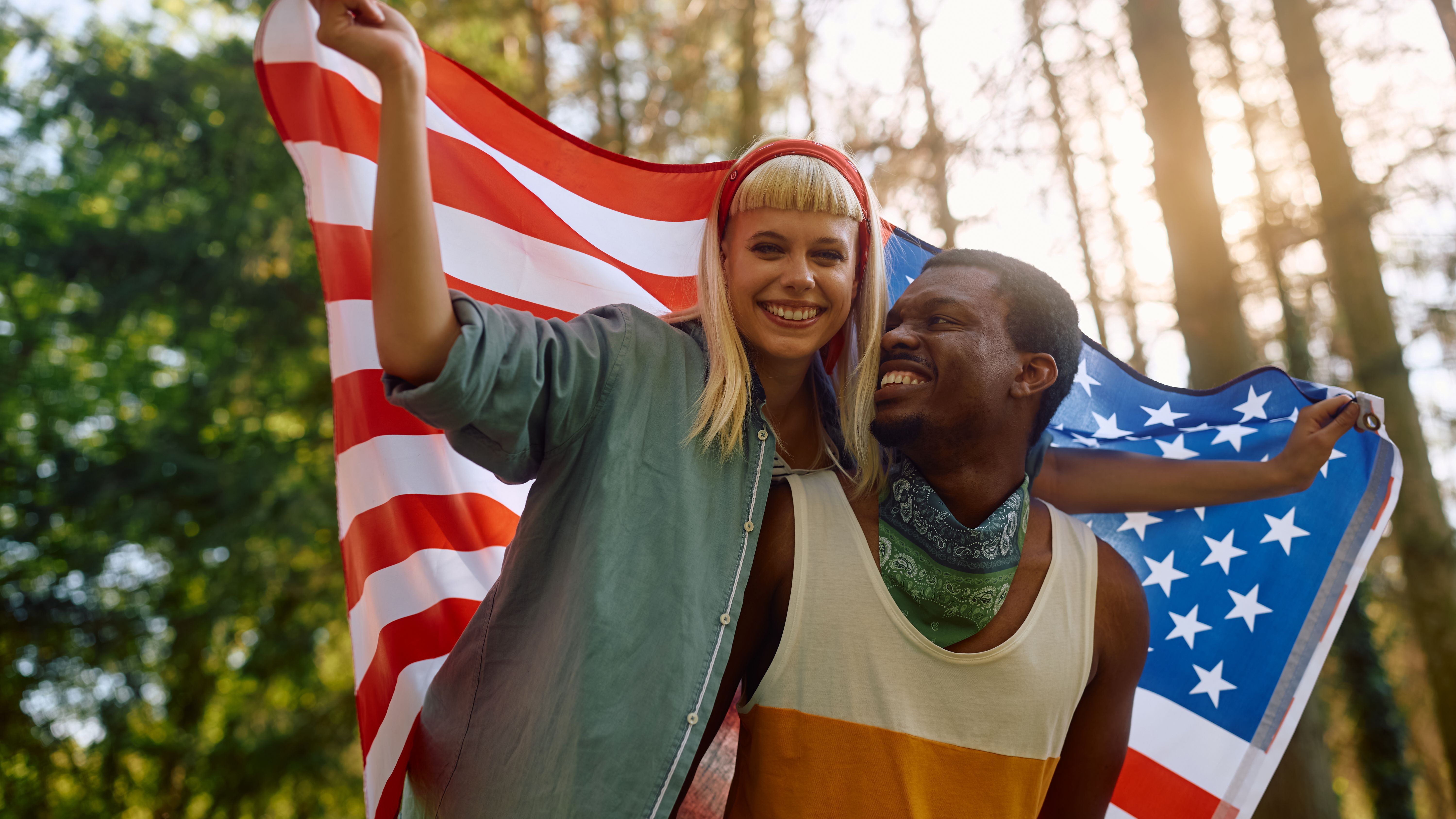 happy-patriotic-couple-with-american-flag-in-natur-2024-12-13-18-33-27-utc.jpg