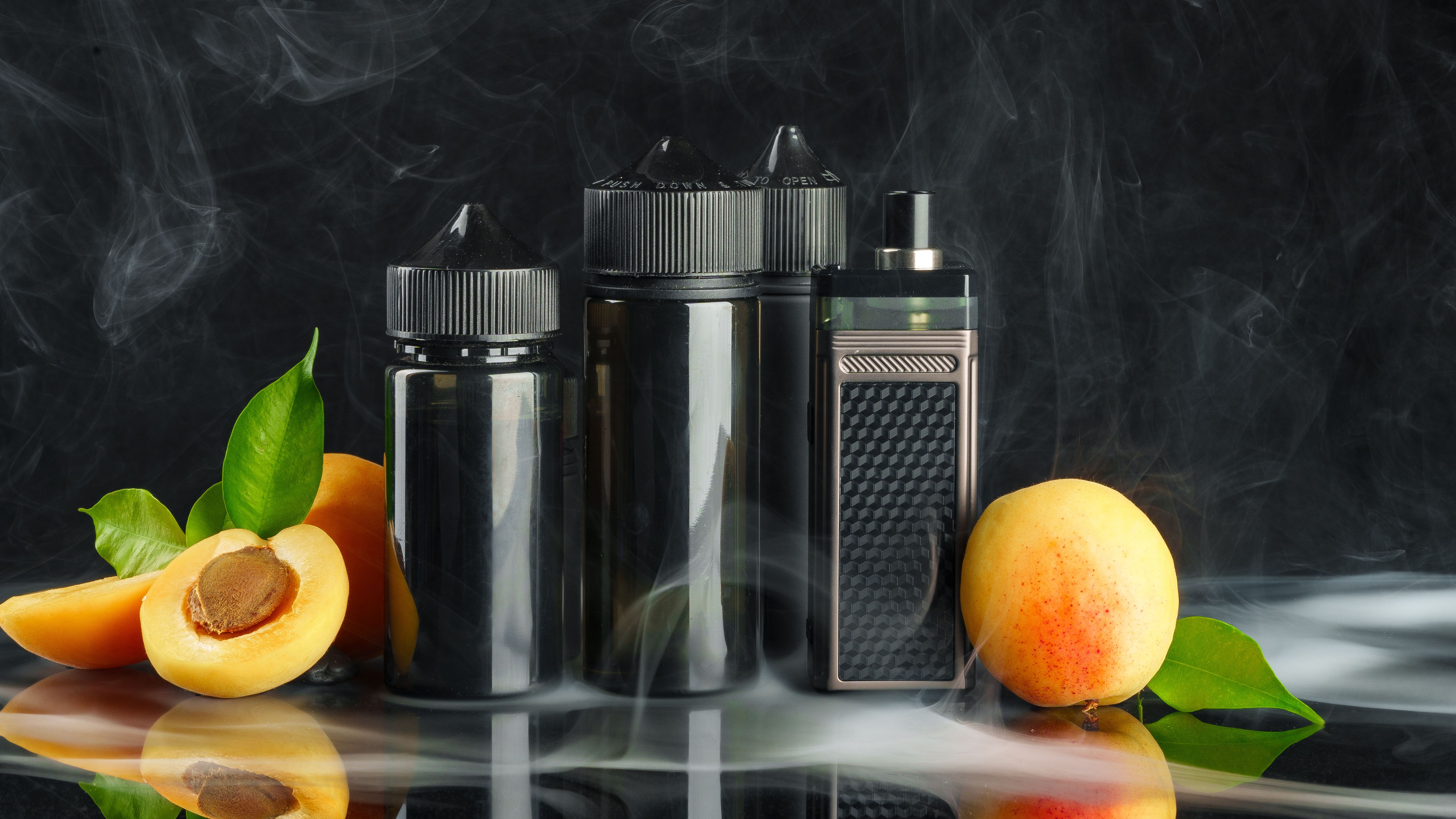 vape-and-smoking-liquid-with-fruit-against-black-b-2025-02-24-18-57-01-utc.jpg