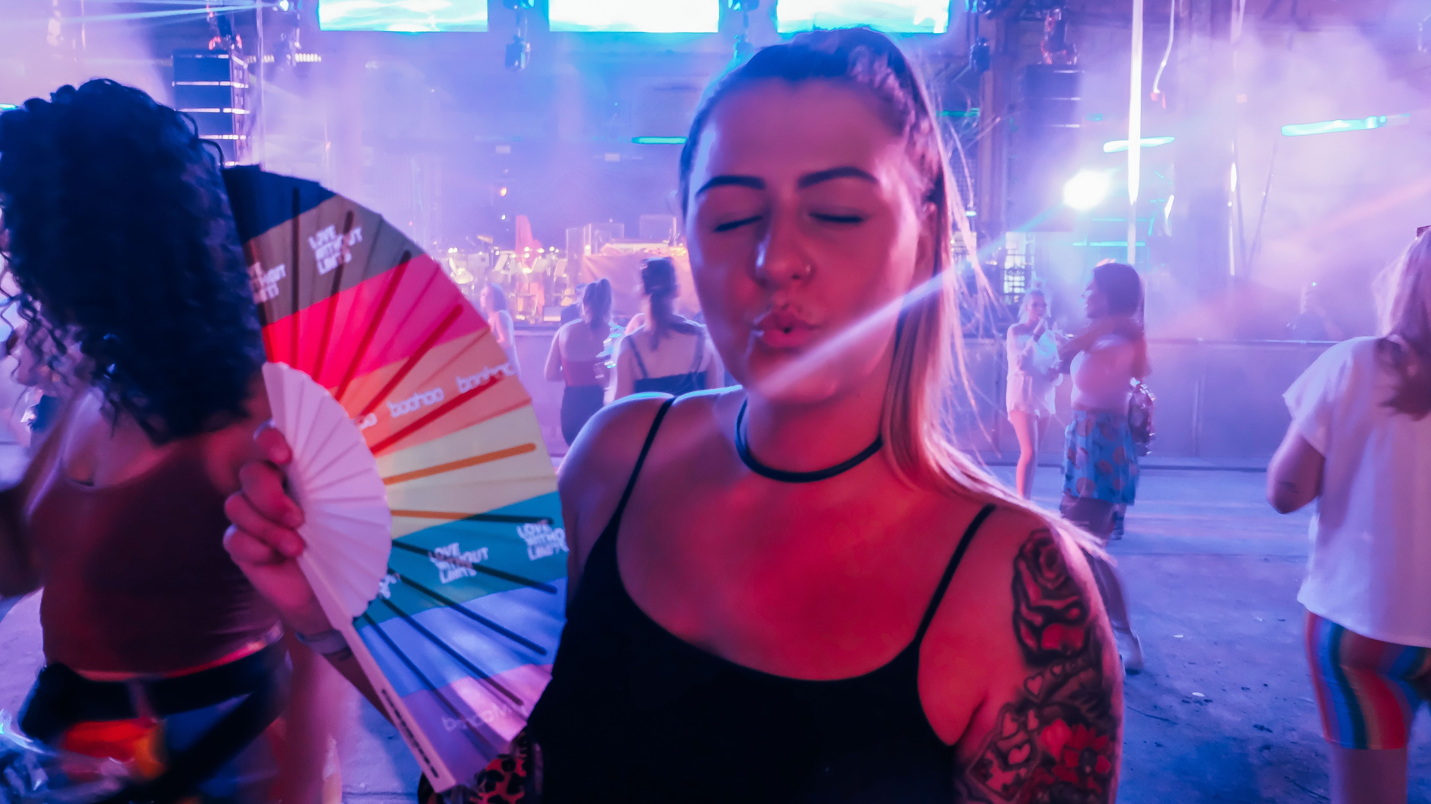 woman-pouting-at-camera-with-handheld-fan-and-manc-2024-10-17-12-12-39-utc.jpg