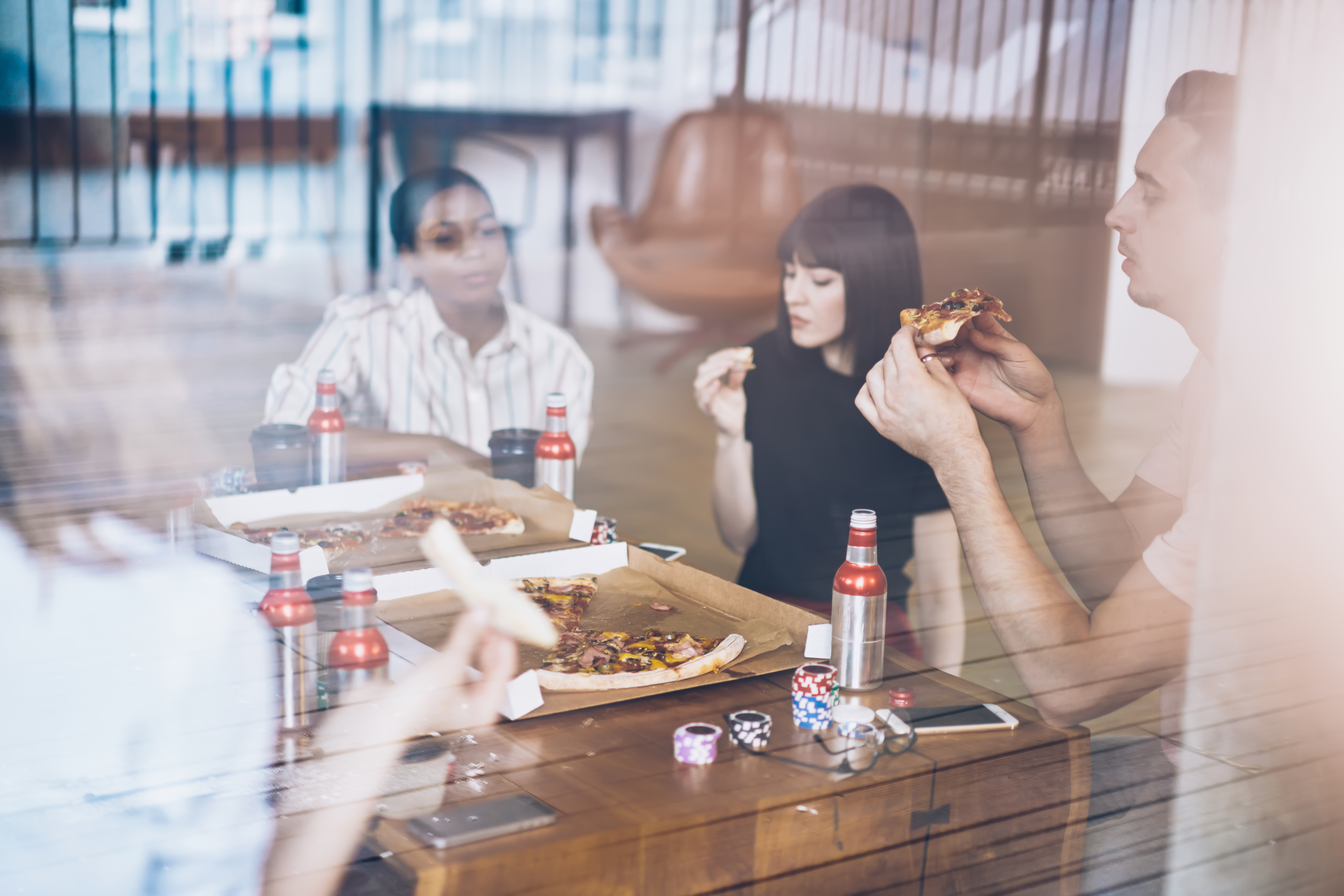 multiracial-group-of-people-enjoying-pizza-in-cafe-2025-03-25-18-43-35-utc.jpg