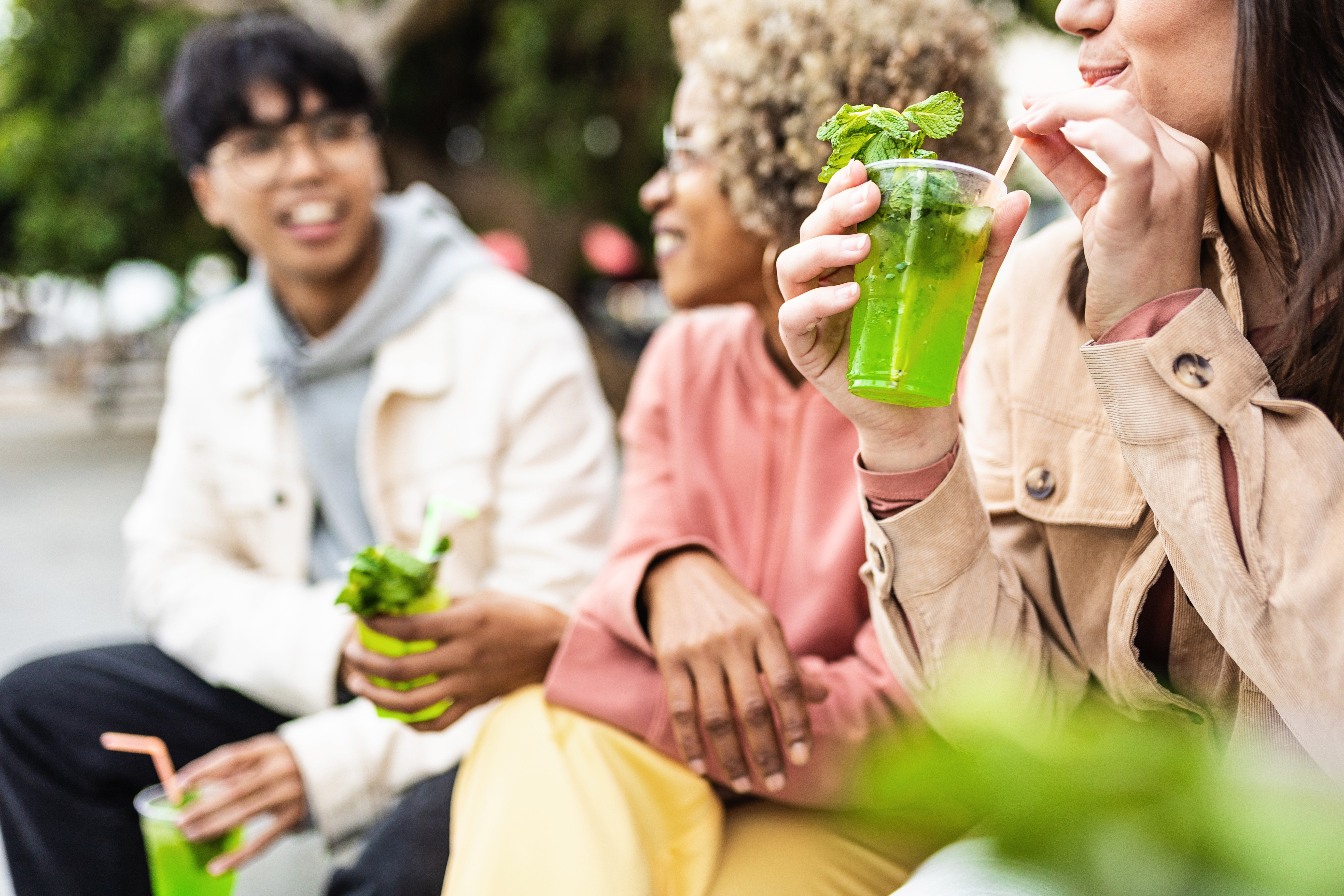 happy-young-friends-drinking-cocktails-outdoors-2025-03-11-08-55-23-utc.jpg