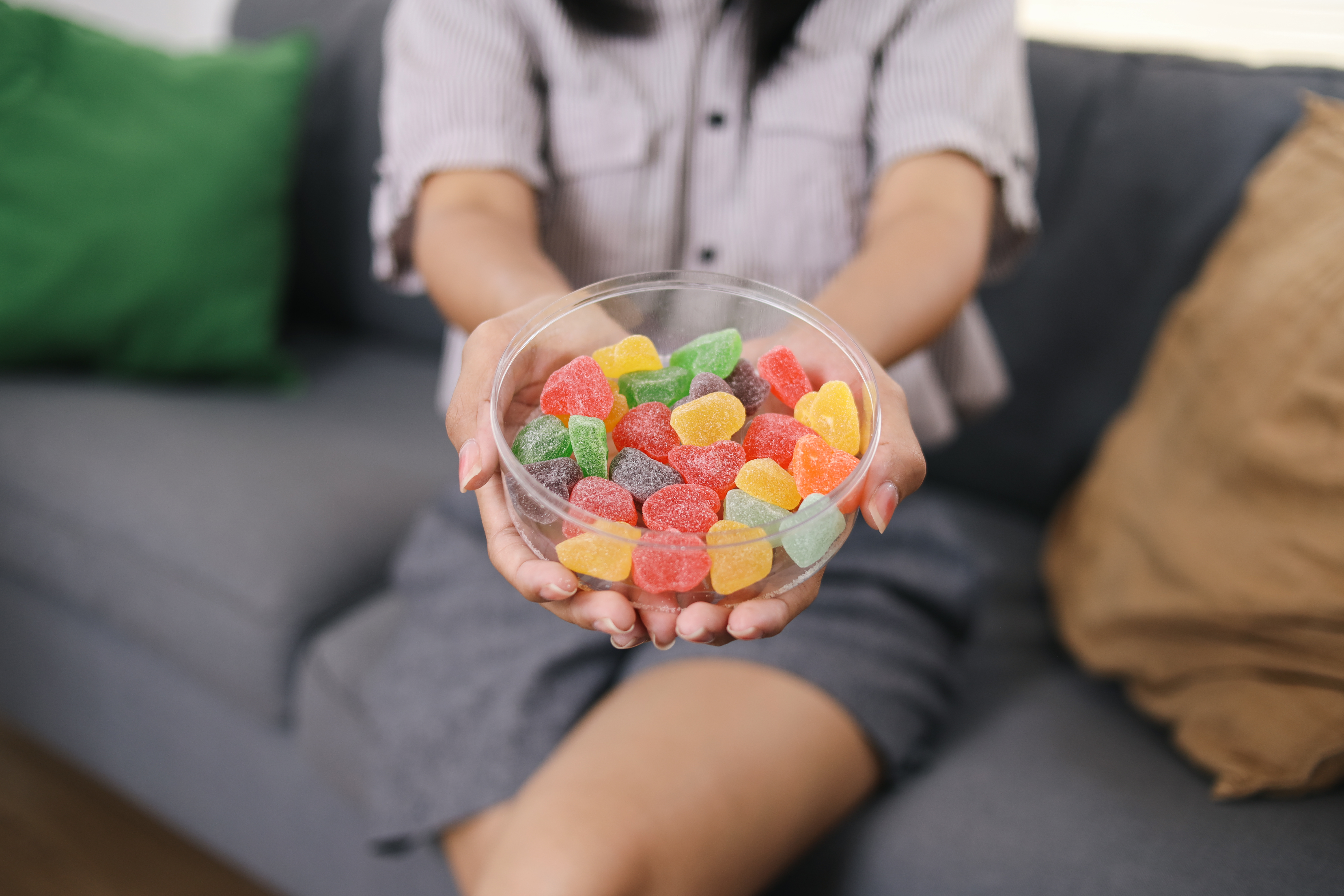 hands-holding-colorful-sugar-candy-on-bowl-2025-03-16-06-54-25-utc.jpg