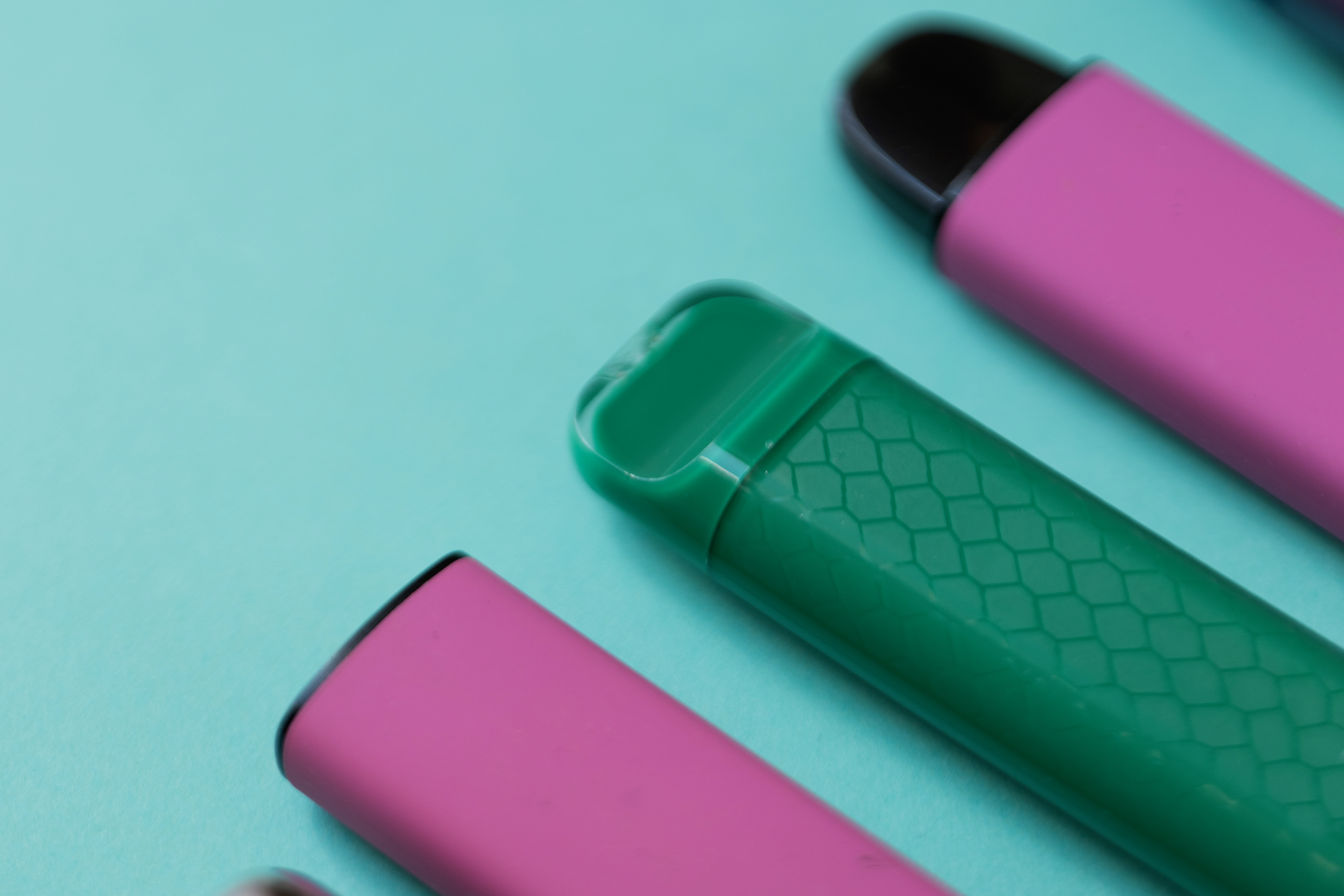 colorful-disposable-vape-devices-on-a-green-backgr-2025-08-27-06-38-08-utc.jpg