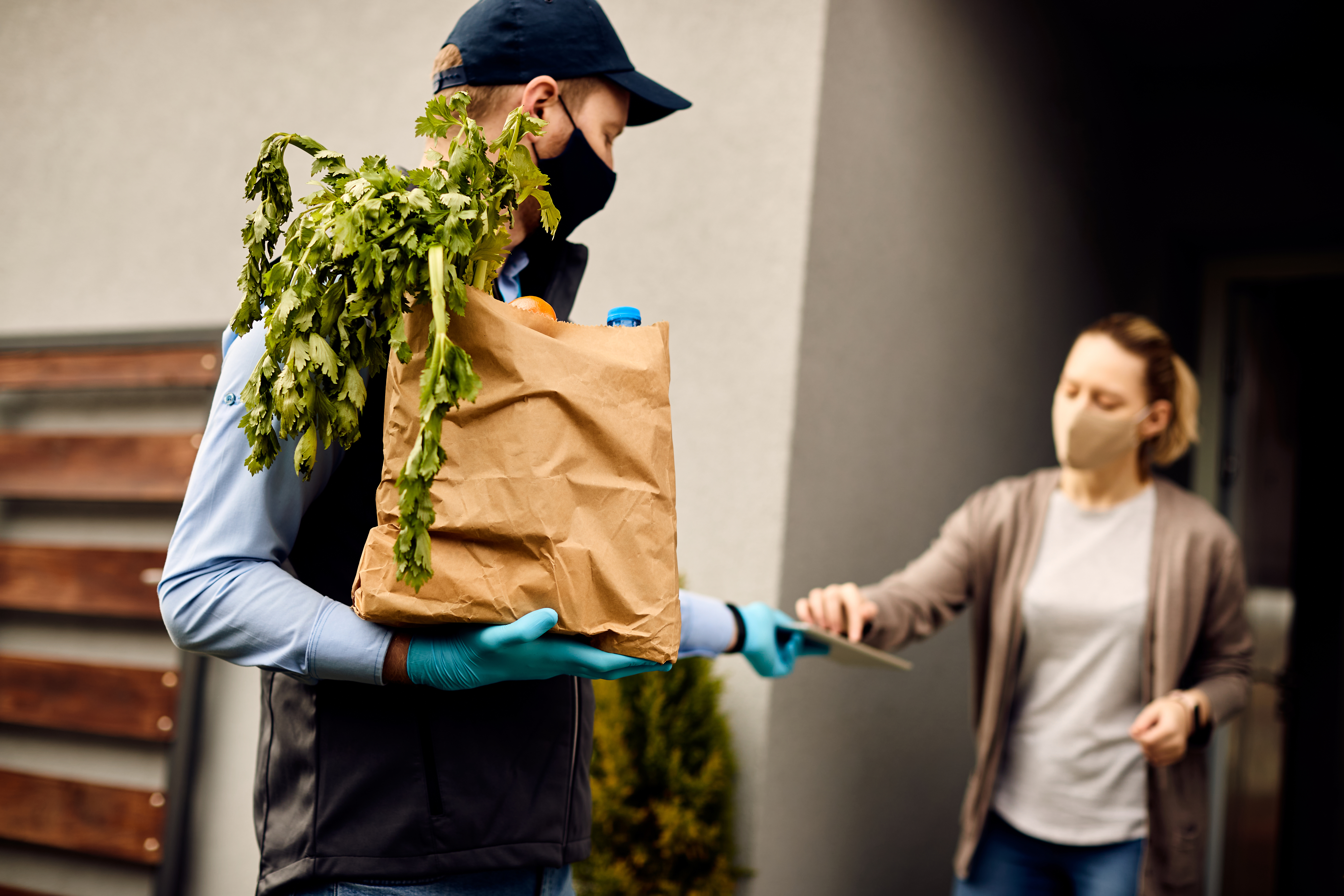 delivery-man-holding-bag-of-Cannabis-Flowers.jpg