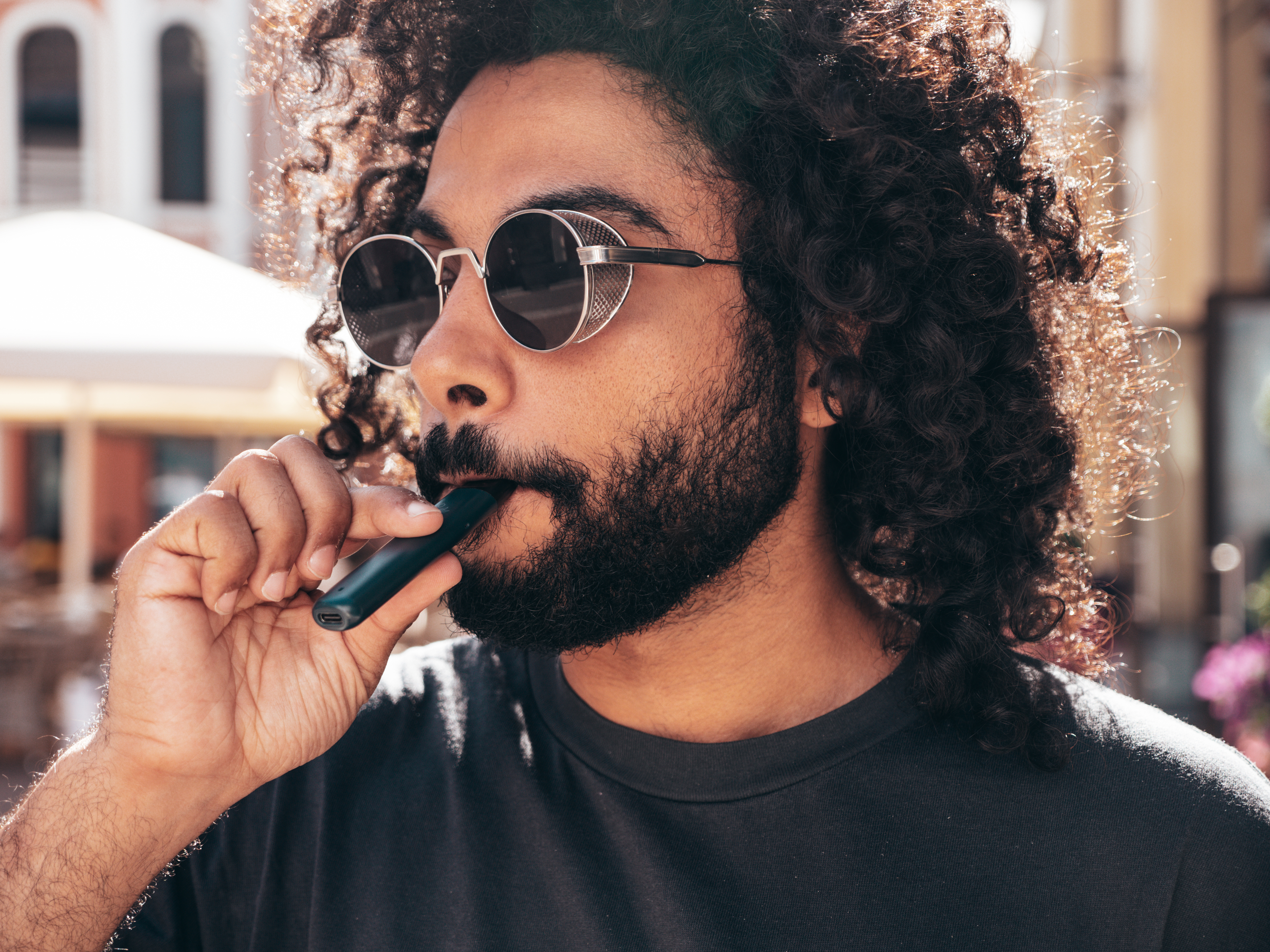 handsome-man-Rechargeable-vape pens-posing-outdoors-at-sunny-day.jpg