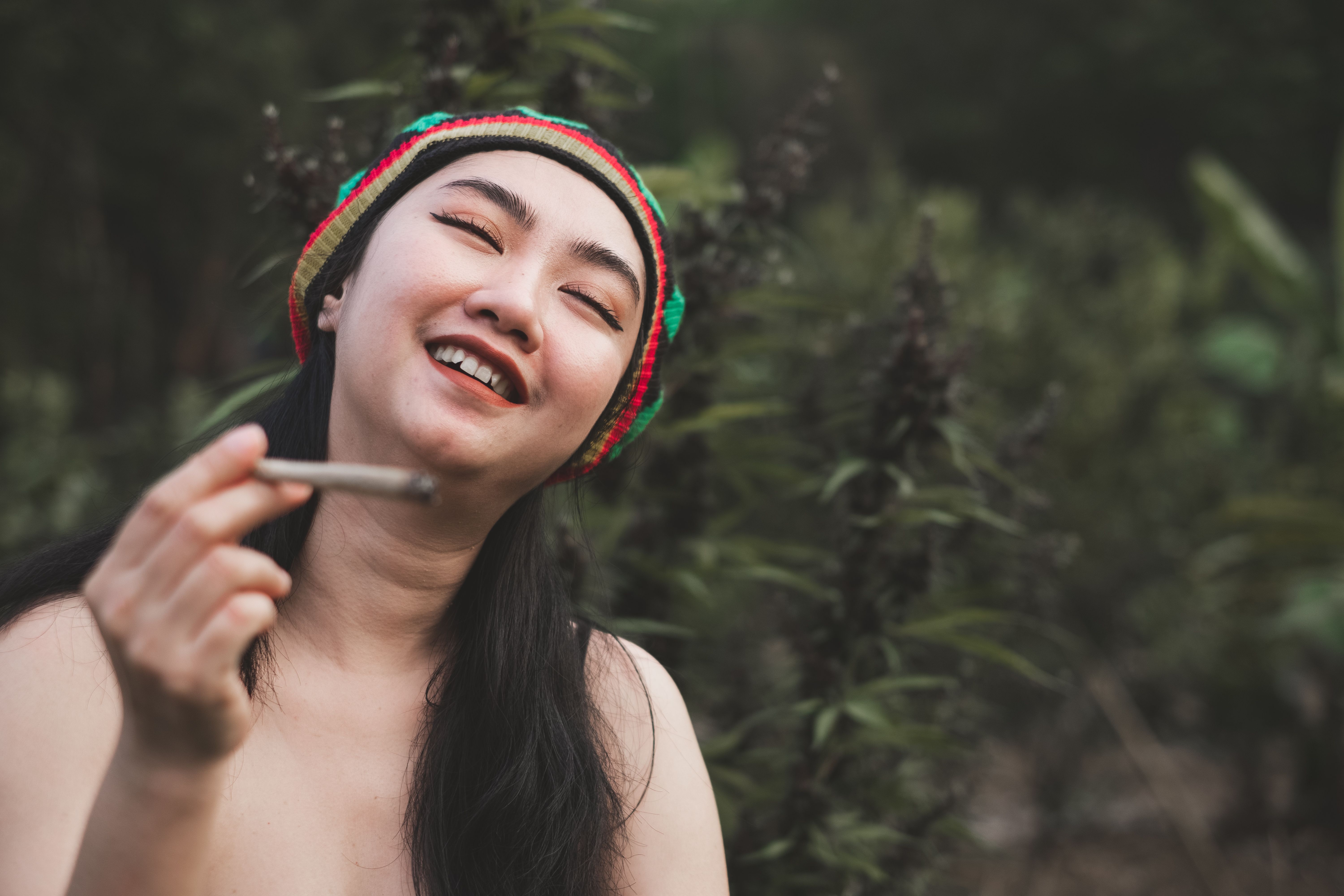 yong-asia-woman-smoking-marijuana-at-cannabis-tree