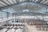 Inside of Jackson Family Wines processing facility which is a large metal building that is full of stainless steel containers.