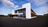 3D rendering of brown and white building with yellow stripe on the side