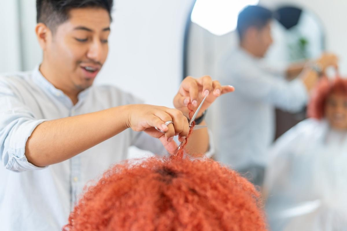 hairdresser-combing-the-curly-hair-of-a-woman-2025-03-09-06-26-52-utc.jpg