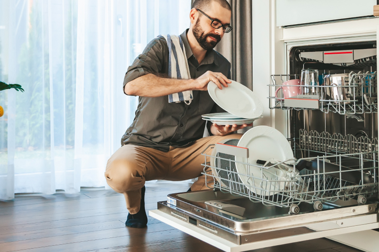 Man unloading dishwasher