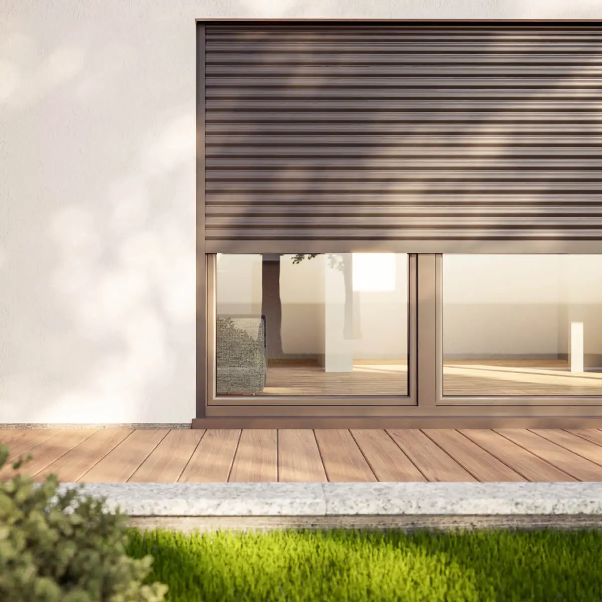 Backyard with decking, lawn looking onto the window of a house with floor to ceiling windows that have a secure shutter installed.