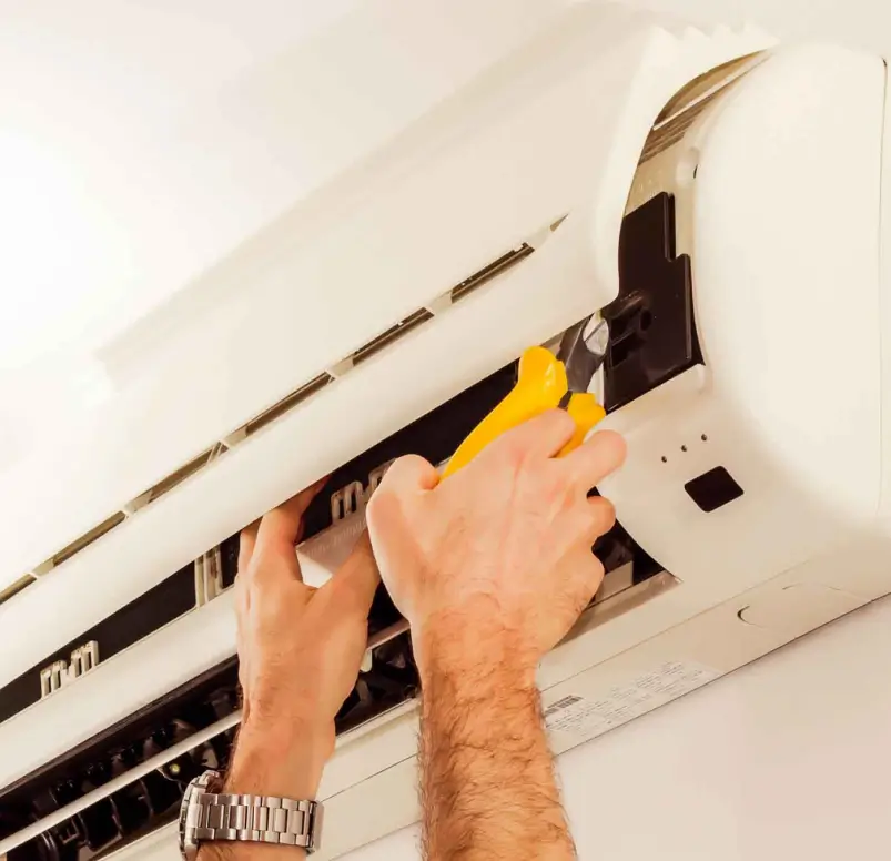 Electrician installing an air conditioning unit