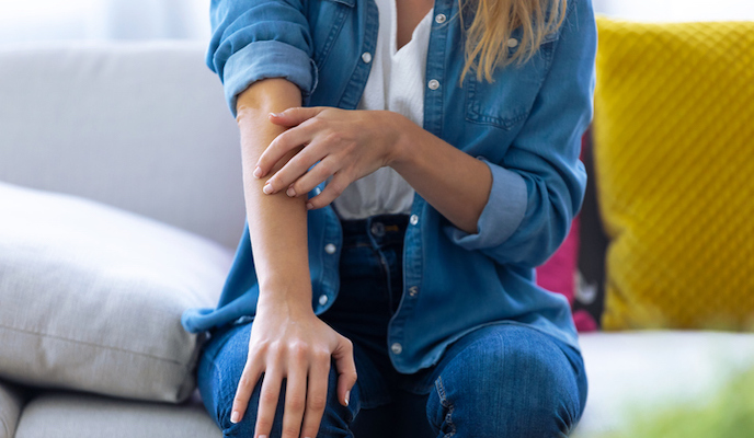 A woman itching her arm.jpg