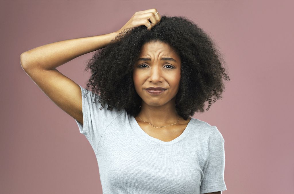 A woman itching her scalp