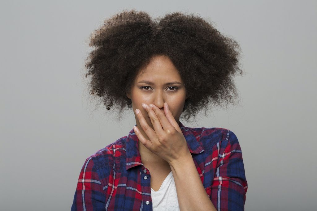 A woman holding her nose