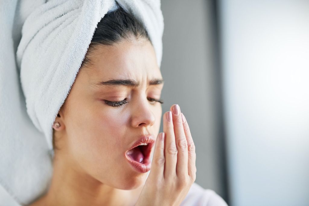 A woman checking her breath