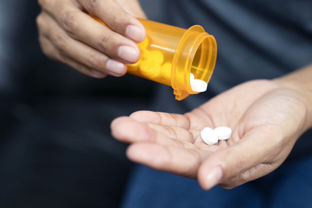  A man dispensing pills into his hand