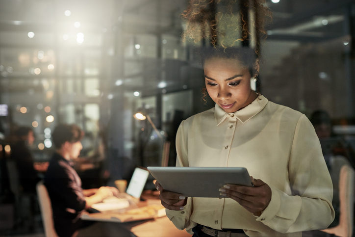 Woman looking down at tablet