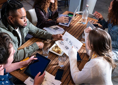 Production accountants discussing film production management and television payroll around a table