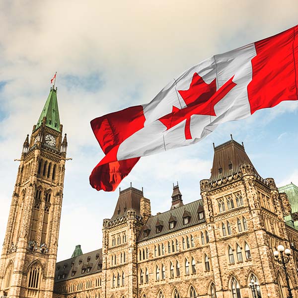 Canadian flag waving over Parliament