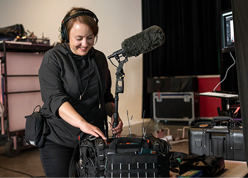 Boom mic operator getting ready for set, film crew management tools