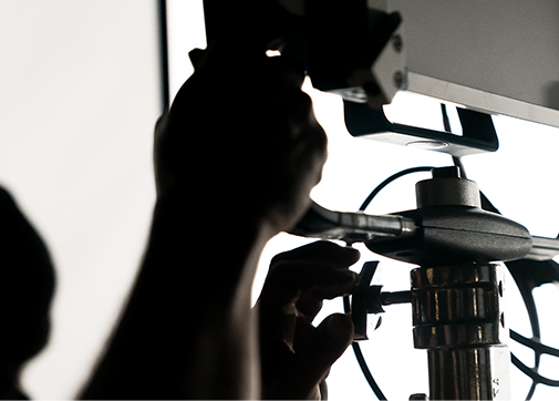 Production worker on set tending to lighting cues