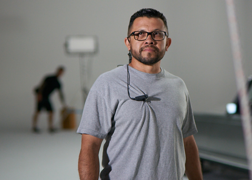 Production worker with ear in looking at the camera