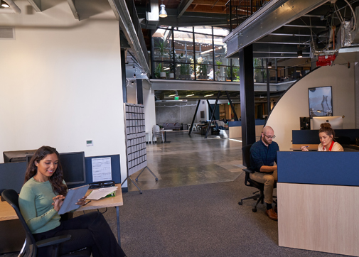 Production workers in office collaborating