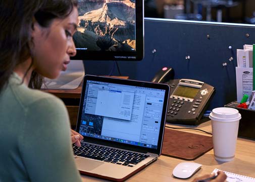 UPM scheduling a film in a production office at a desk