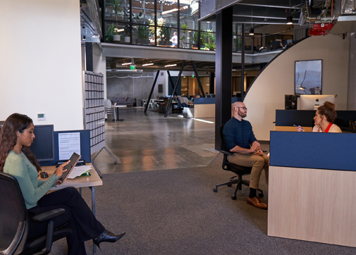 Production workers collaborating in the studio office