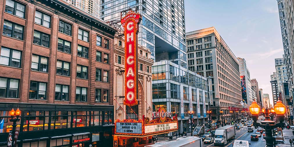 Illinois tax incentive alert - wide image of Chicago city street with tall buildings and red sign