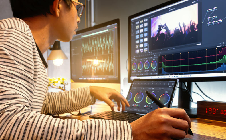 Video editor looking at monitors