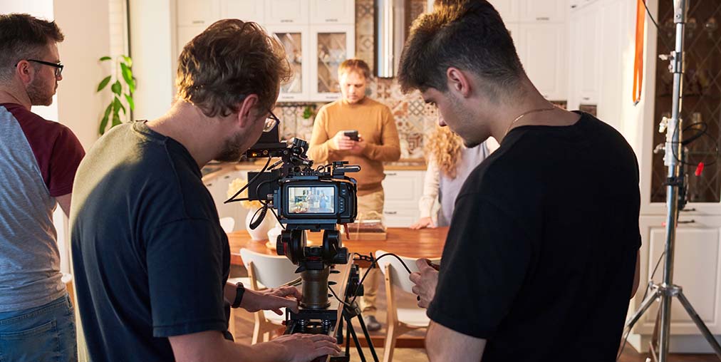 videographer and assistant adjusting video camera on production set-production incentives update March 2026