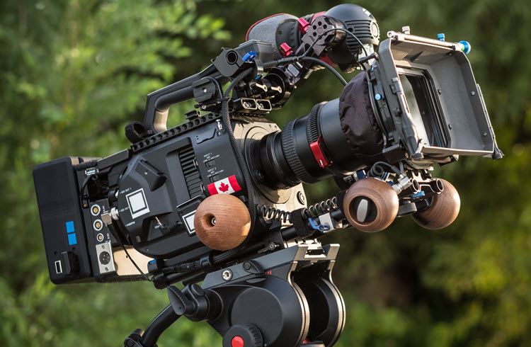 Cinema camera with Canadian flag decal on set, representing EP Scenechronize for Canadian productions