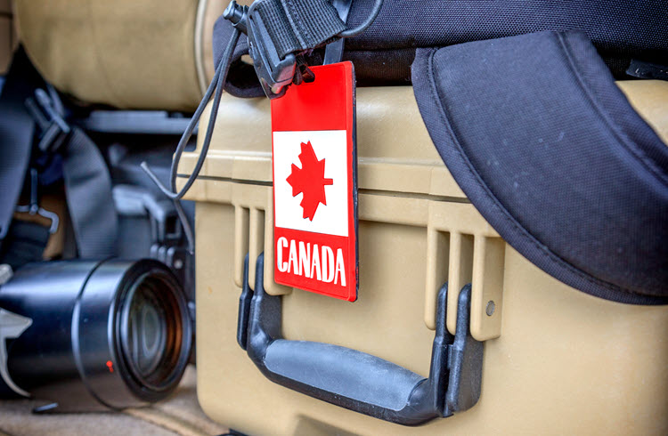Canada flag luggage tag on production camera equipment case, representing EP Production Accounting Analytics for Canadian productions