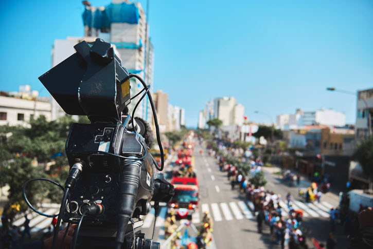Camera filming parade scene from above