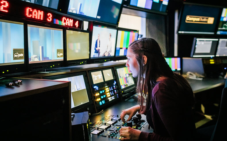 Broadcast control room operator monitoring live camera feeds and production switcher.