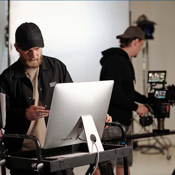 Line producer looking at a computer screen on a film set