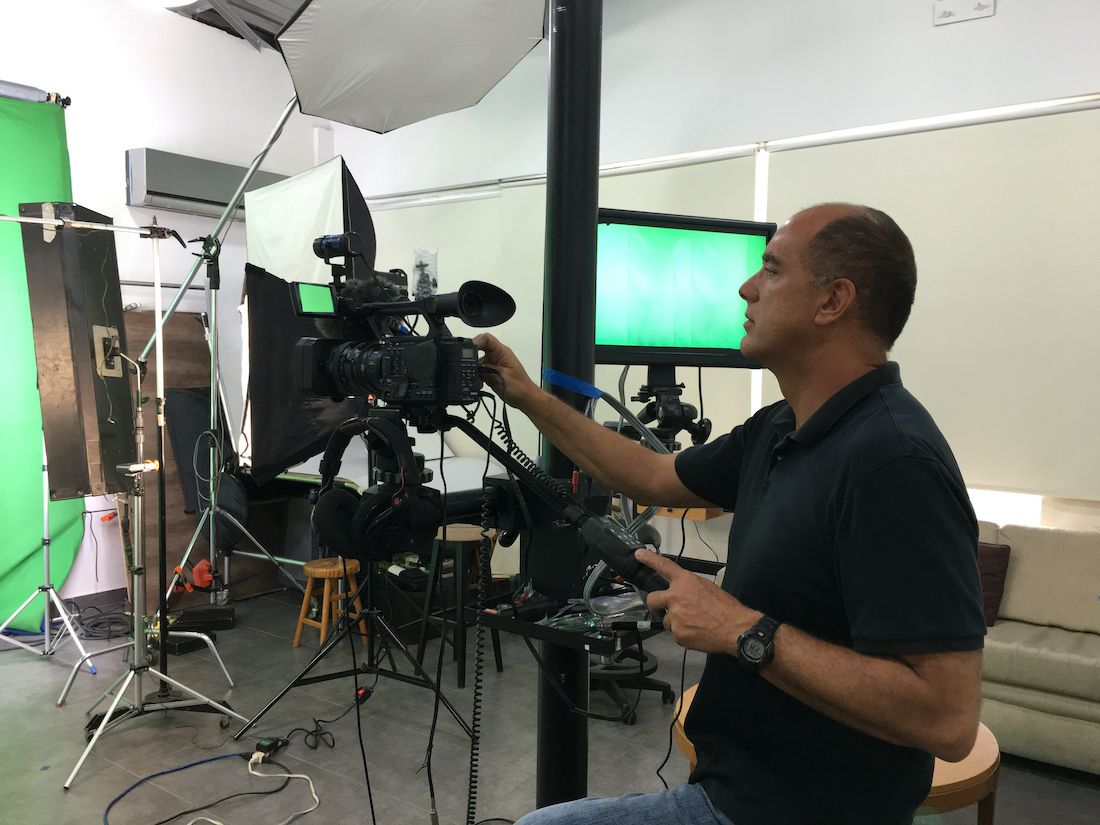 Videographer at work filming video in studio set