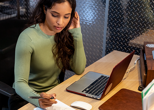 production back office working on film payroll at a desk